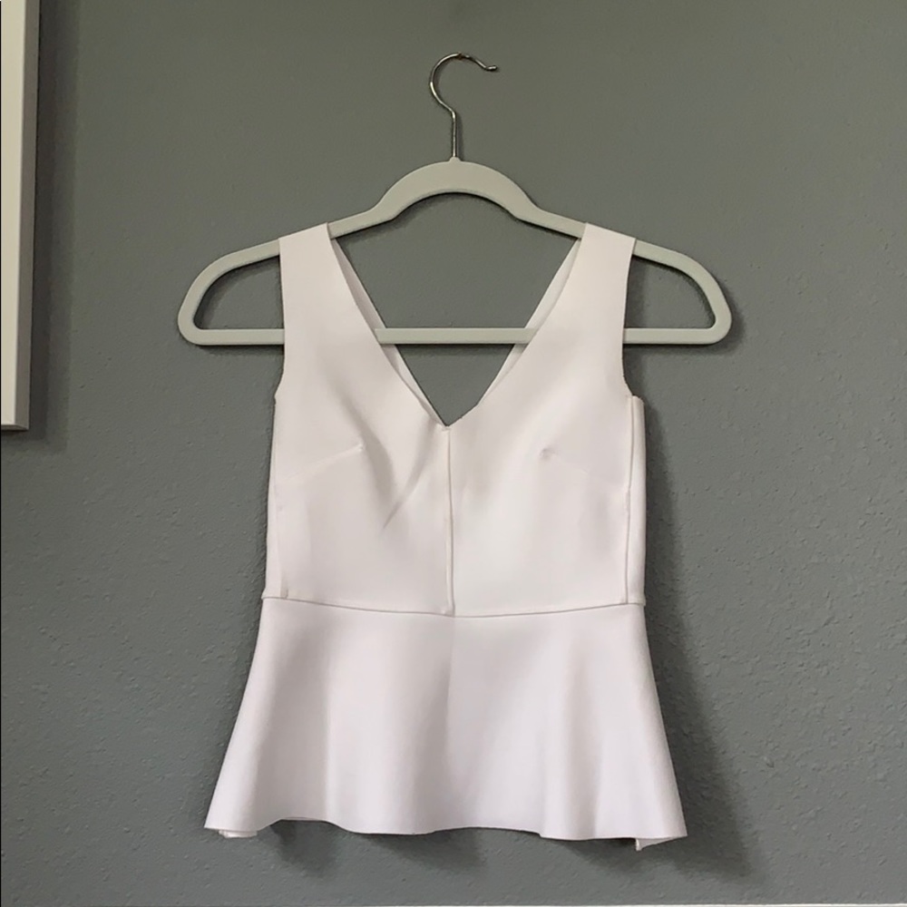 Laser cut white peplum top